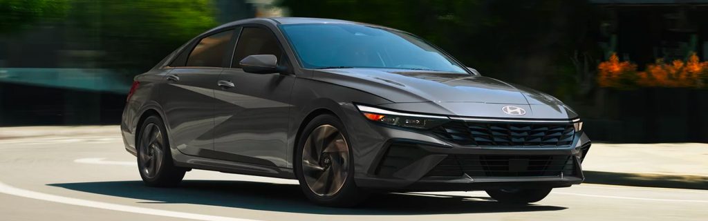 2026 Hyundai Elantra Hybrid driving on a city street.